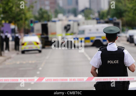 Belfast, Nordirland. 13.07.2013 - steht Polizist von der Polizei Wache bei einer Polizei Kordon Punkt während Armee ATOs von Royal Logistik Corp befassen sich mit einer verdächtigen Bombe. Stockfoto