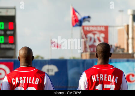 HAARLEM, NIEDERLANDE, 15.07.2012. Feldspieler Rusney Castillo (links) und Guillermo Heredia Molina (rechts) von Team Kuba die Hymne hören und schauen Sie sich ihre Flagge vor dem Spiel gegen die USA bei den Haarlem Baseball Woche 2012. Stockfoto