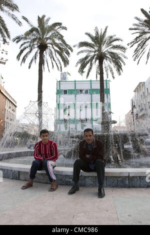 1. März 2006 - Tripolis - zwei Männer sitzen von einem Brunnen auf dem grünen Platz mit Gaddafi Porträt mit Blick auf die Szene, Tripolis, Libyen, 2006 (Credit-Bild: © Veronika Lukasova/ZUMAPRESS.com) Stockfoto