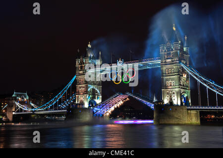 London, England, UK Freitag, 27. Juli 2012 Tower Bridge Feuerwerk Licht auf der Themse als die Olympische Fackel hier gesehen als eine Lichtspur unter der Brücke, die letzte Etappe der Reise braucht, um das Olympiastadion. London, Gastgeber der 30. Olympischen Spiele vorbereitet für die Eröffnungsfeier mit einem Feuerwerk und Licht zeigen auf Tower Bridge, City of London, England, UK Stockfoto