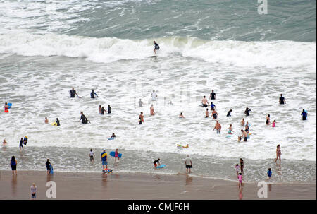 Langland Bucht, Swansea, Großbritannien. Donnerstag, 16. August 2012. Surfer und Urlauber machen das Beste aus den Wellen bei Langland Bucht in der Nähe von Swansea heute Nachmittag während einer Pause bei nassem Wetter. Stockfoto