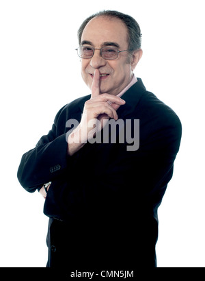 Isolierte corporate männliche Gesten Stille mit Finger auf den Mund Stockfoto