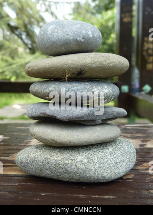 Zen Steinen auf ein Stück Holz in einem park Stockfoto