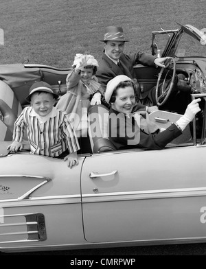 1950ER JAHREN LÄCHELND FAMILIE PORTRAIT MUTTER VATER SOHN TOCHTER IN CHEVROLET CABRIO AUTO Stockfoto