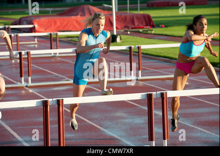 Läufer, die Hürden im Rennen Stockfoto