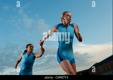 Läufer in Staffellauf Staffelstab übergeben Stockfoto