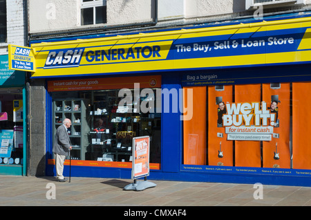 Mann, Blick auf die Schaufenster von Cash Generator, Dalton Road, Furness, Cumbria, England UK Stockfoto