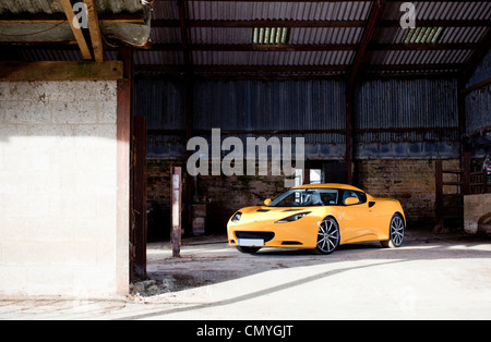 Gelbe Lotus Evora Sportwagen auf einer Farm in England, UK. Schnell zwei Sitzer Supersportwagen erfolgt in Norfolk. Stockfoto