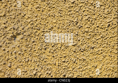 Sandy brown, holprigen Textur eines Gebäudes Stuck. Stockfoto