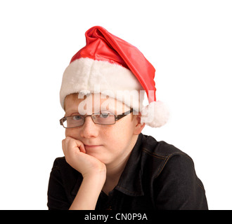 Ein 12-jähriger Junge, mit einem leichten Lächeln, einen "Santa" Hut Stockfoto