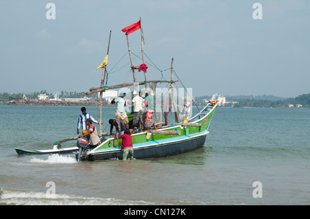 Sri Lankan Fischer werfen ihre outrigger Katamaran von Galle Sri Lanka Stockfoto