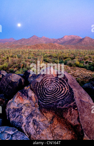 Ein Vollmond steigt über einen alten Spirale Petroglyphen gefunden im Saguaro National Park in Süd-Arizona Stockfoto