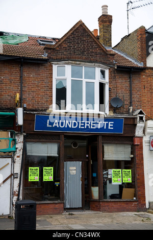 Aufgegeben und mit Brettern vernagelt alt / geschlossene Herunterfahren-up / Fensterläden verfallenen Wäsche / Waschsalon shop in Twickenham. London. VEREINIGTES KÖNIGREICH. Stockfoto