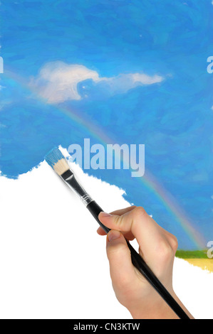 Die Hand mit einem Pinsel zeichnet eine Landschaft. Blauer Himmel, Feld und Regenbogen Stockfoto