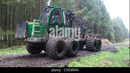 Kommerzielle Forstwirtschaft ein Spediteur, Geländewagen, Kommissionierung Aufarbeitung schneiden Bäume Holz im Wald Forestry Commission, UK Stockfoto