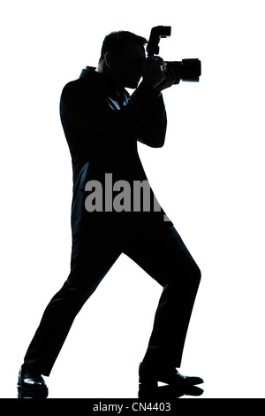 ein kaukasischer Mann Fotograf in voller Länge Silhouette im Studio isoliert weißen Hintergrund Stockfoto