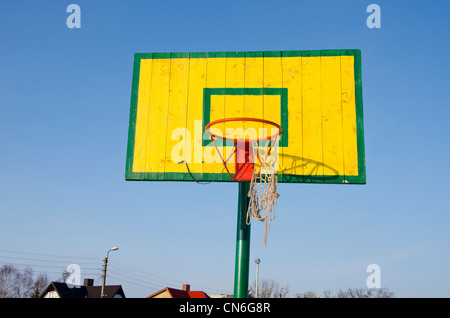 Basketball-Korb mit zerfetzten Bogen Masche auf Hintergrund des blauen Himmels. Bunte Freizeitaktivitäten Spielobjekt. Stockfoto