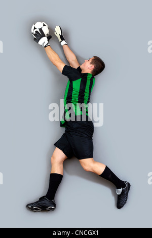 Porträt von einem Torhüter in Bewegung, die den Ball fängt Stockfoto