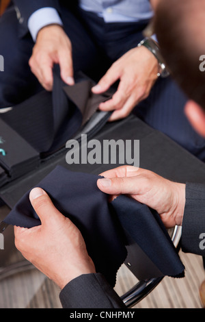 Detail der beiden Männer halten Stoffmuster Stockfoto