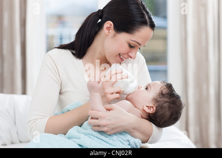 Mutter mit der Flasche füttern Baby boy Stockfoto