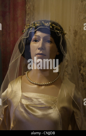 Schaufensterpuppe trägt eine Hochzeit Kleid hinter einem Glaskasten in einem Museum. Stockfoto