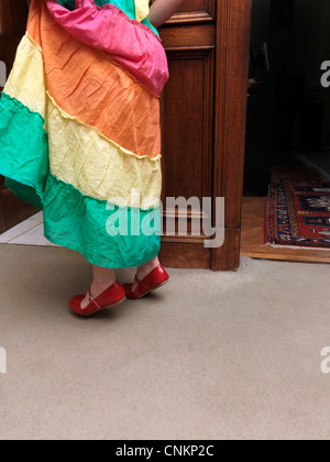 Junges Mädchen Tipp zeheneng In roten Schuhen durch Tor in England Stockfoto