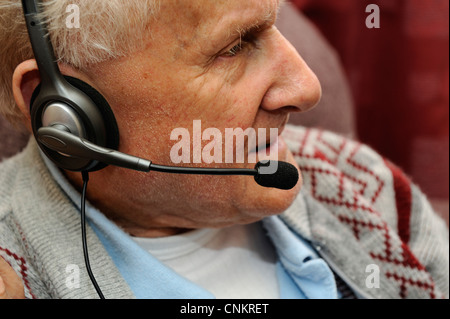 männliche Rentner mit Kopfhörer und Mikrofon England uk Stockfoto