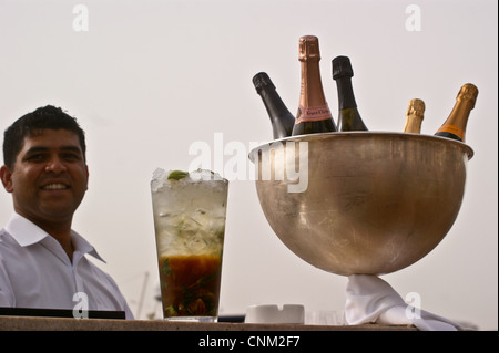 Barkeeper mit einem Cocktail und Flaschen Veuve Clicquot Champagner im Park Hyatt Hotel, Dubai Creek, Dubai, Vereinigte Arabische Emirate Stockfoto