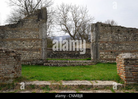 Saepinum, die Ruinen eines römischen Kirchengebäudes. Saepinum, die Ruinen eines römischen Kirchengebäudes. Das Gebäude neben dem Makellum war vermutlich für Gottesdienste vorgesehen. Es bestand aus einem quadratischen Raum, dem ein großer, aus gemischten Steinblöcken und Ziegelgürteln gebauter Pronaos vorausging. Die Eingangstür zum Innenraum ist mit Stangen aus geformten Steinblöcken versehen; die Steinschwelle bewahrt die Löcher für die Scharniere einer doppelflügeligen Tür. Stockfoto