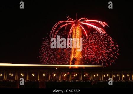 Parisern und Touristen beobachten Bastille Day Feuerwerk rund um den Eiffelturm mit Passy Brücke im Vordergrund in Paris, Frankreich. Stockfoto