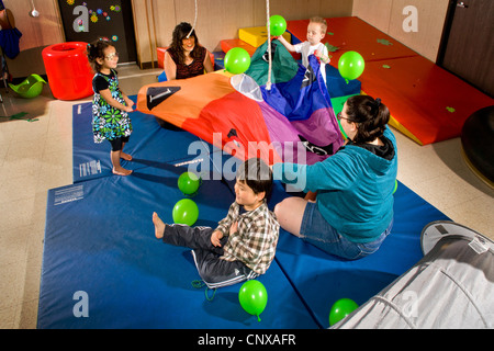 Lehrer und sehbehinderte Schüler Welle einen Fallschirm, Problemlösung in einer sensorischen motor Gruppe zu fördern. Stockfoto