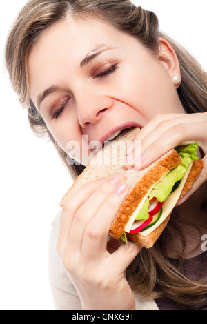 Schöne junge glücklich Frau Essen Sandwich, isoliert auf weißem Hintergrund. Stockfoto