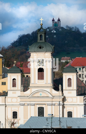 Pfarrkirche in Banska Stiavnica mit Kalvarienberg im Hintergrund, Slowakei Stockfoto