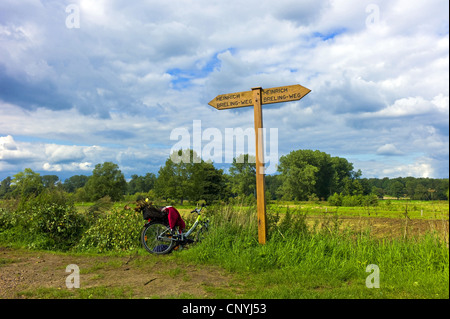 Fahrrad mit einem Wegweiser für Wanderer an der Wümme, Deutschland, Niedersachsen, Verden, Fischerhude Stockfoto