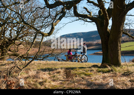 Zwei Radfahrer ausruhen Rhodeswood Reservoir in den Longdendale Valley, Peak District, Derbyshire, England, UK Stockfoto