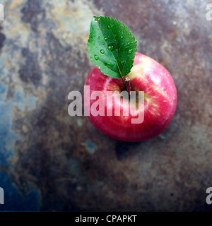 Pink Lady Apfel auf Schiefer mit einem Blatt Stockfoto