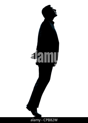 eine kaukasische Business Mann Silhouette stehend Zehenspitzen blickte voller Länge im Studio isoliert auf weißem Hintergrund Stockfoto