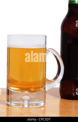 Eine Tasse kaltes Bier in der Nähe ein dunkles Bierflasche Stockfoto