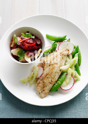 Platte mit Fisch mit Bohnen und Obstsalat Stockfoto