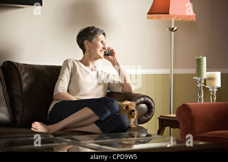 Ältere Frau auf Sofa am Telefon sprechen Stockfoto