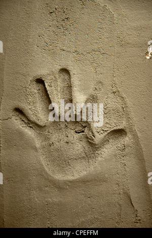 Hand auf Zement Mörtel Mauer mit Schatten Relief print Stockfoto