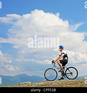 Ein Mann posiert mit dem Mountainbike auf einem Bergrücken in Mazedonien Stockfoto