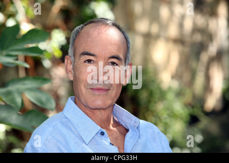 Älterer Mann stand im Garten Stockfoto