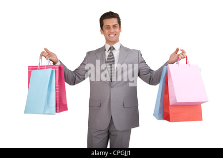 Geschäftsmann, Einkaufstaschen tragen. Stockfoto