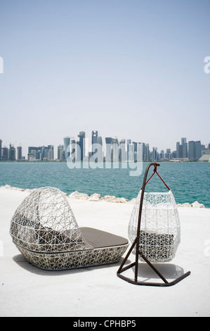 Moderne Sitzgelegenheiten im Freien im Waterfront Café mit Blick auf Skyline von Doha in Katar