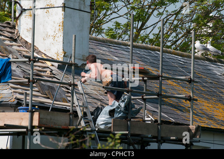 Dachdecker-Generator arbeitet auf einem Hausdach Stockfoto