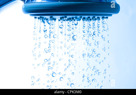 Duschkopf mit Tröpfchen Wasser, blauer Hintergrund Stockfoto