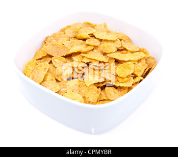 Haufen von Cornflakes in eine Schüssel geben, isoliert auf weiss Stockfoto