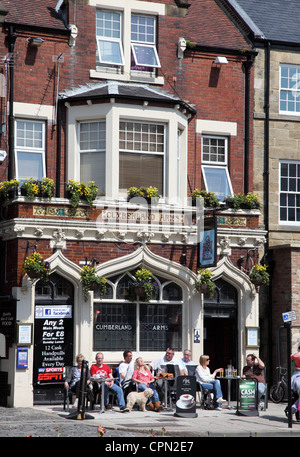 Leute sitzen trinken außerhalb Cumberland Arms Pub auf Tynemouth High Street, North East England, UK Stockfoto