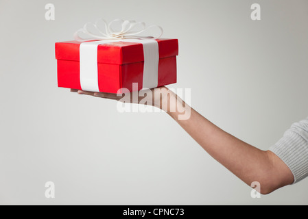 Frau Arm hielt Geschenk-Box, beschnitten Stockfoto